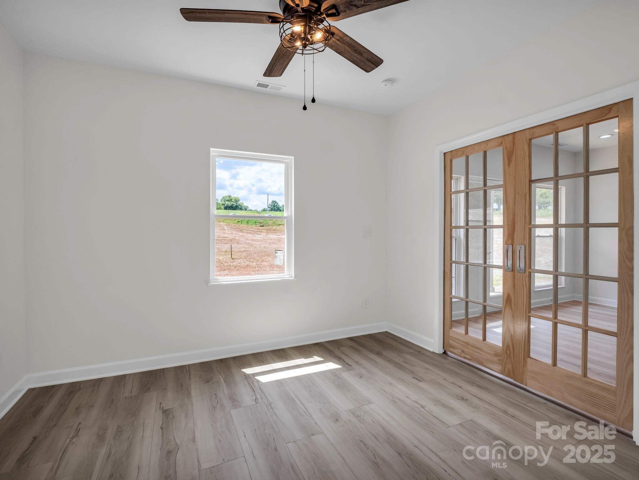 174 Charlie Randall Road Lawndale, NC 28090 - Photo 31 of 41 a view of empty room with wooden floor and fan