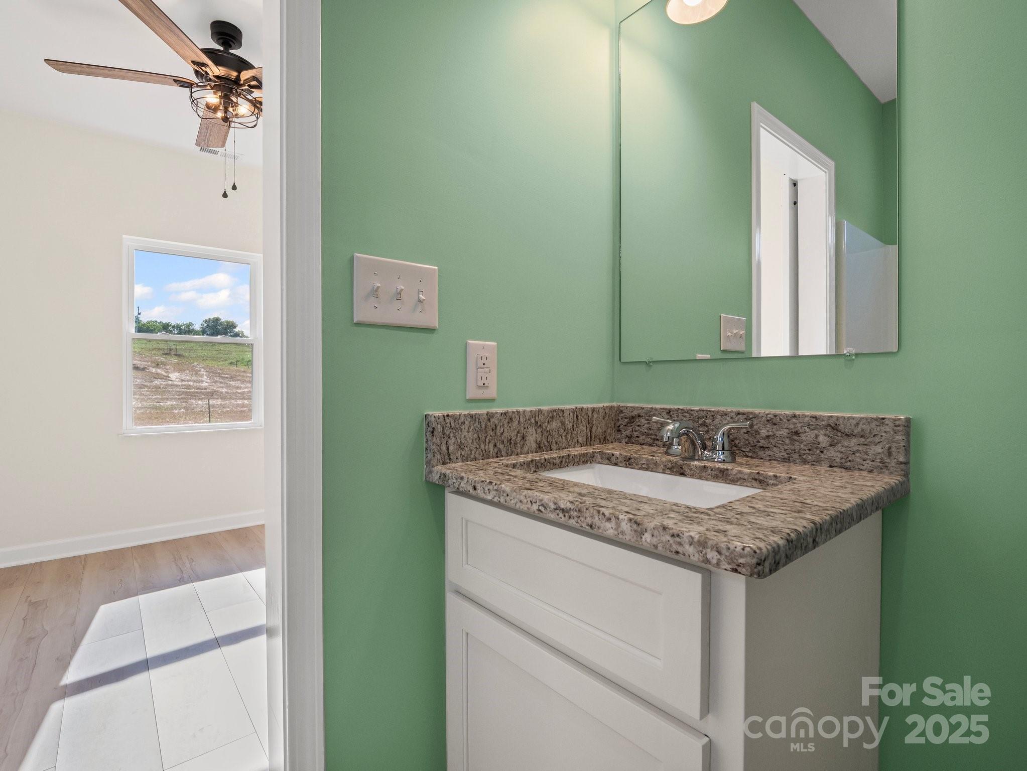 174 Charlie Randall Road Lawndale, NC 28090 - Photo 35 of 41 a bathroom with a granite countertop sink and a mirror