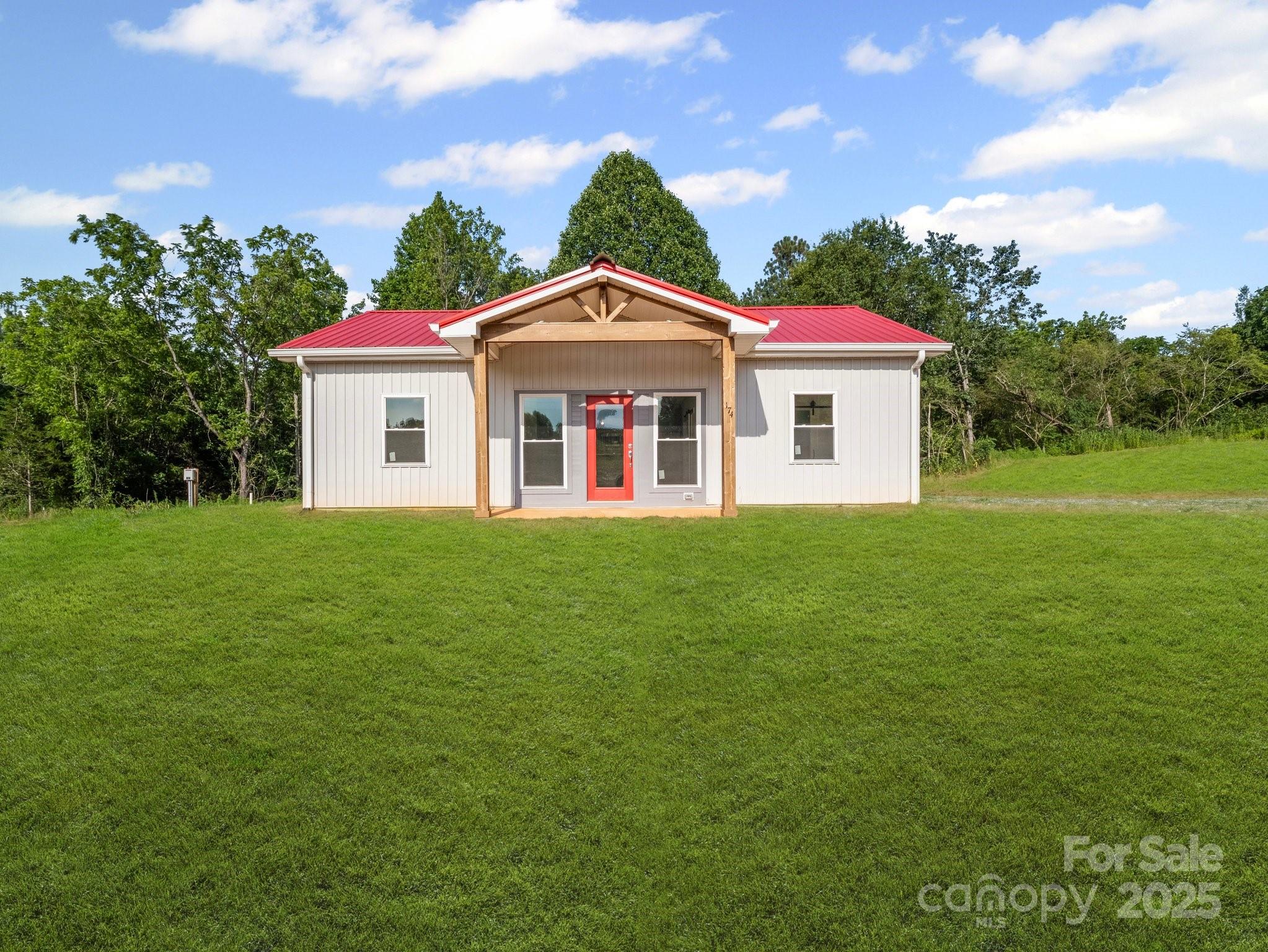 174 Charlie Randall Road Lawndale, NC 28090 - Photo 4 of 41 a front view of a house with a yard