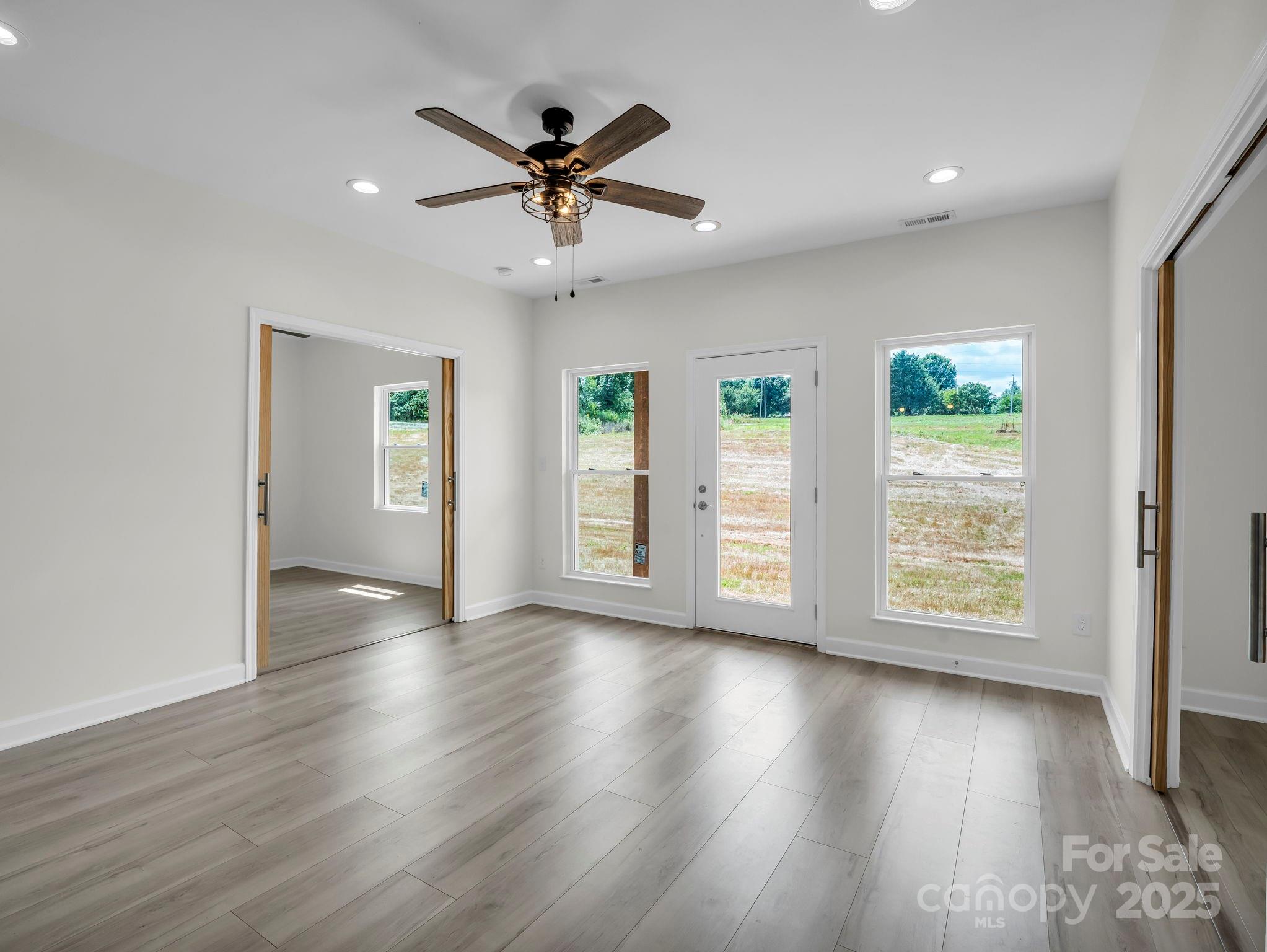 174 Charlie Randall Road Lawndale, NC 28090 - Photo 5 of 41 a view of an empty room with wooden floor and a window