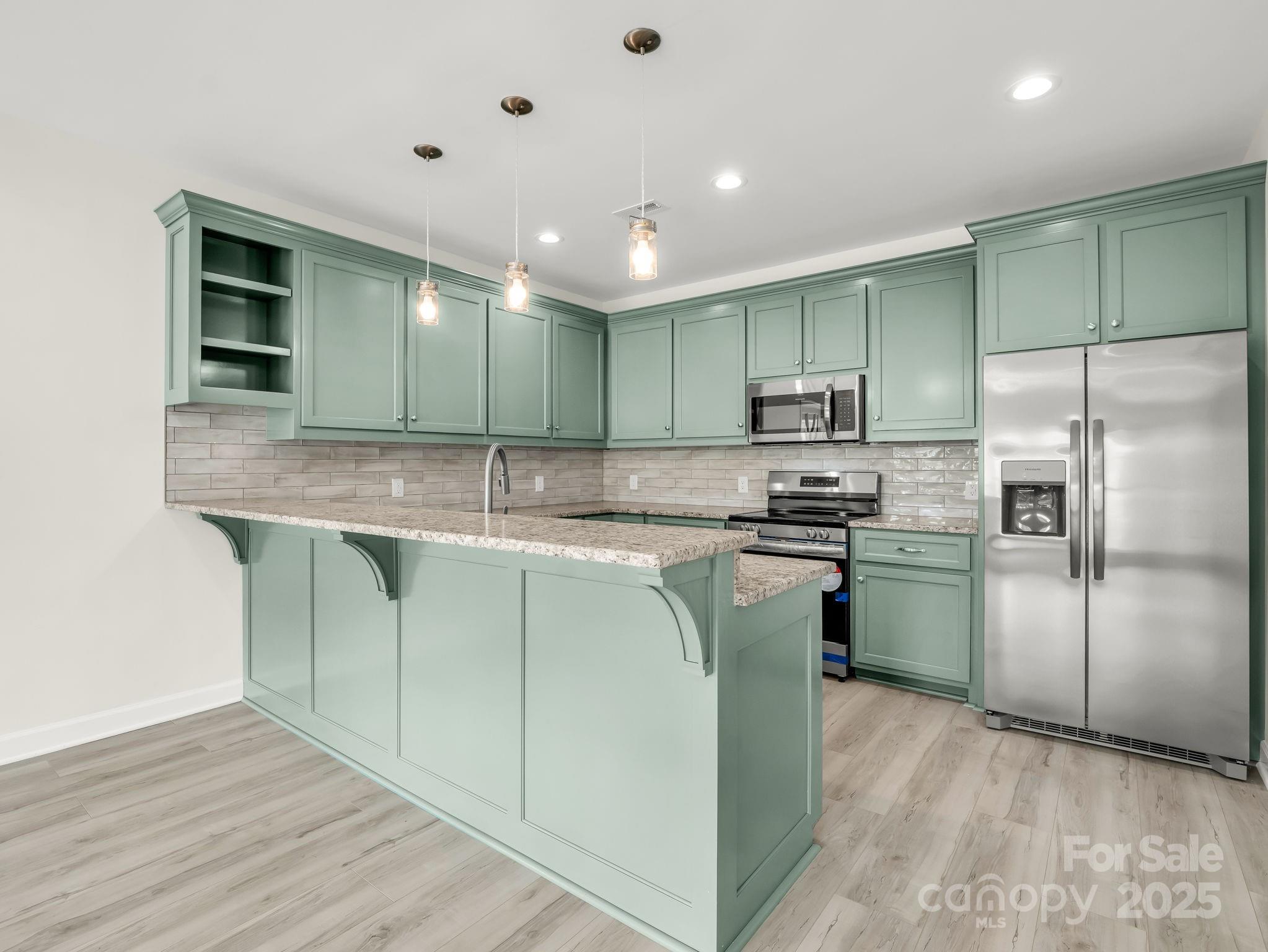 174 Charlie Randall Road Lawndale, NC 28090 - Photo 8 of 41 a kitchen with kitchen island a counter top space cabinets and stainless steel appliances