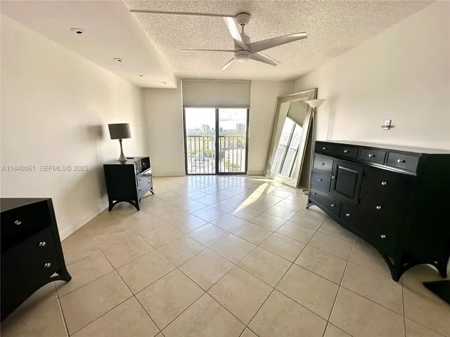 a bedroom with a bed a couch and a large window