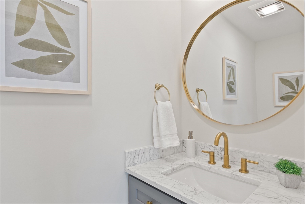 28 Sutherland Road, Unit 28 Arlington, MA 02476 - Photo 18 of 40 a bathroom with a sink and a mirror
