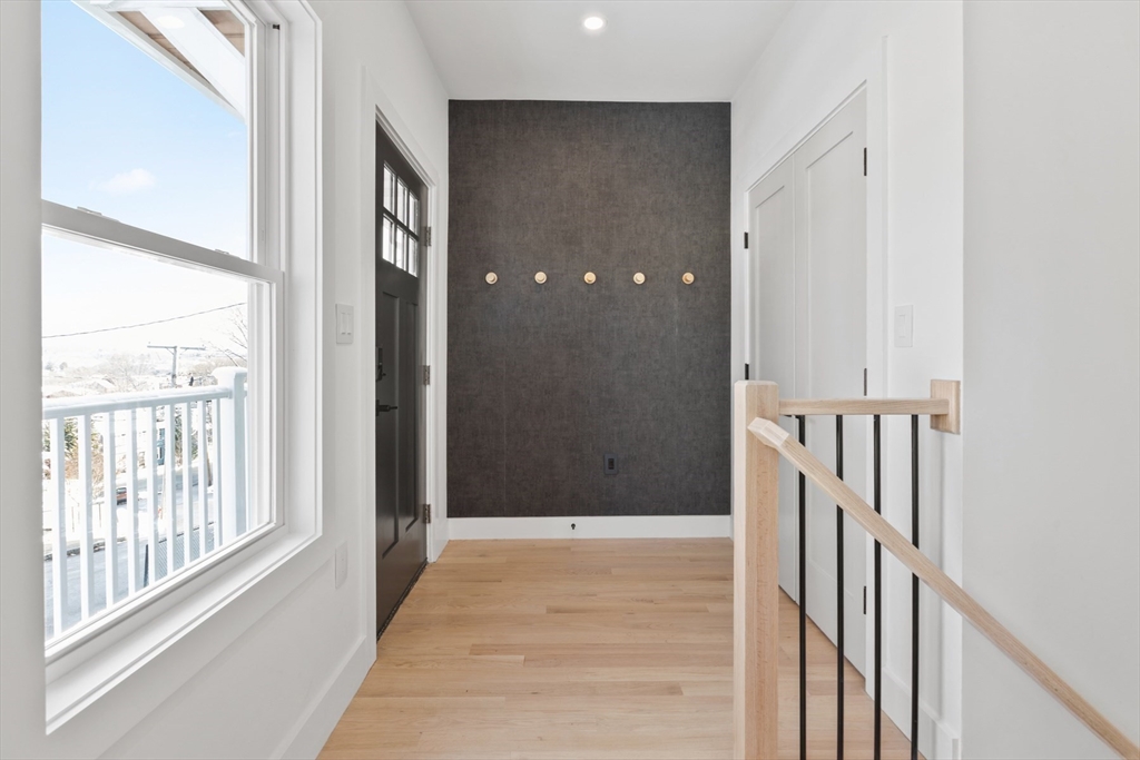 28 Sutherland Road, Unit 28 Arlington, MA 02476 - Photo 2 of 40 a view of a hallway with wooden floor and entryway