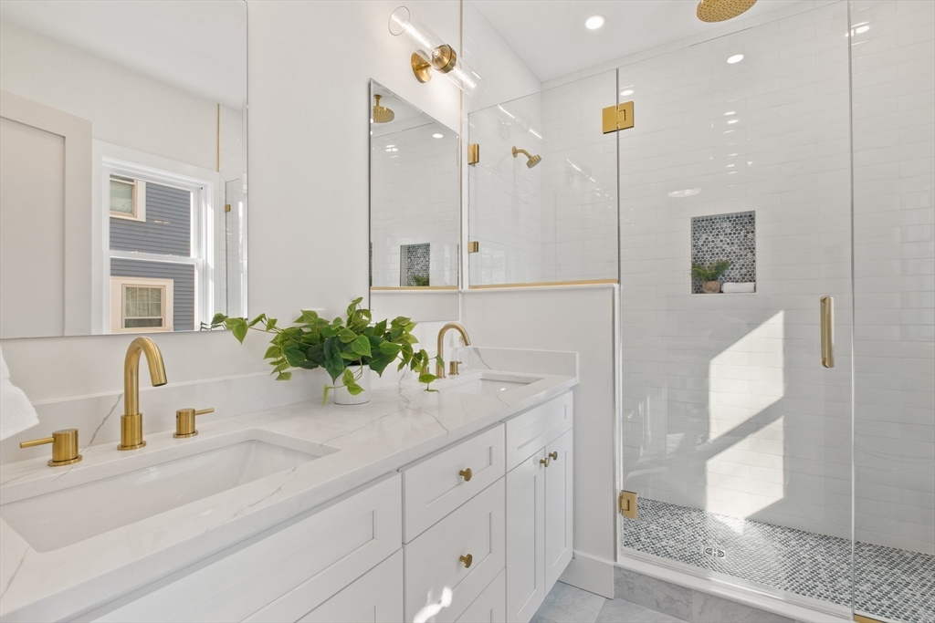 28 Sutherland Road, Unit 28 Arlington, MA 02476 - Photo 21 of 40 a bathroom with a sink a potted plant and a mirror
