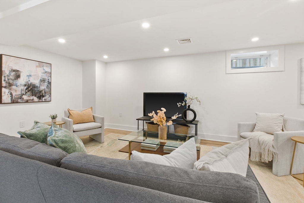 28 Sutherland Road, Unit 28 Arlington, MA 02476 - Photo 29 of 40 a living room with furniture and a couch