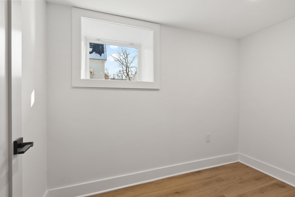 28 Sutherland Road, Unit 28 Arlington, MA 02476 - Photo 35 of 40 a view of a small space with wooden floor and a window