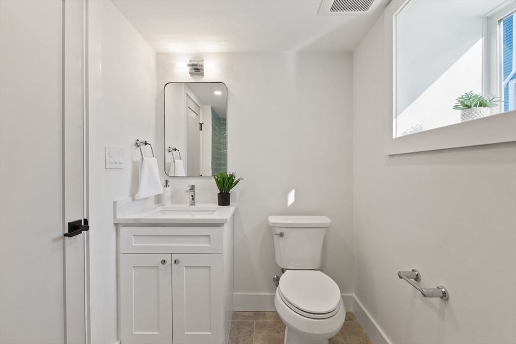 28 Sutherland Road, Unit 28 Arlington, MA 02476 - Photo 36 of 40 a bathroom with a toilet a sink and mirror