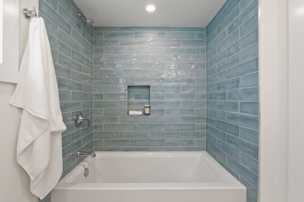 28 Sutherland Road, Unit 28 Arlington, MA 02476 - Photo 37 of 40 a close up of a bathtub in a bathroom