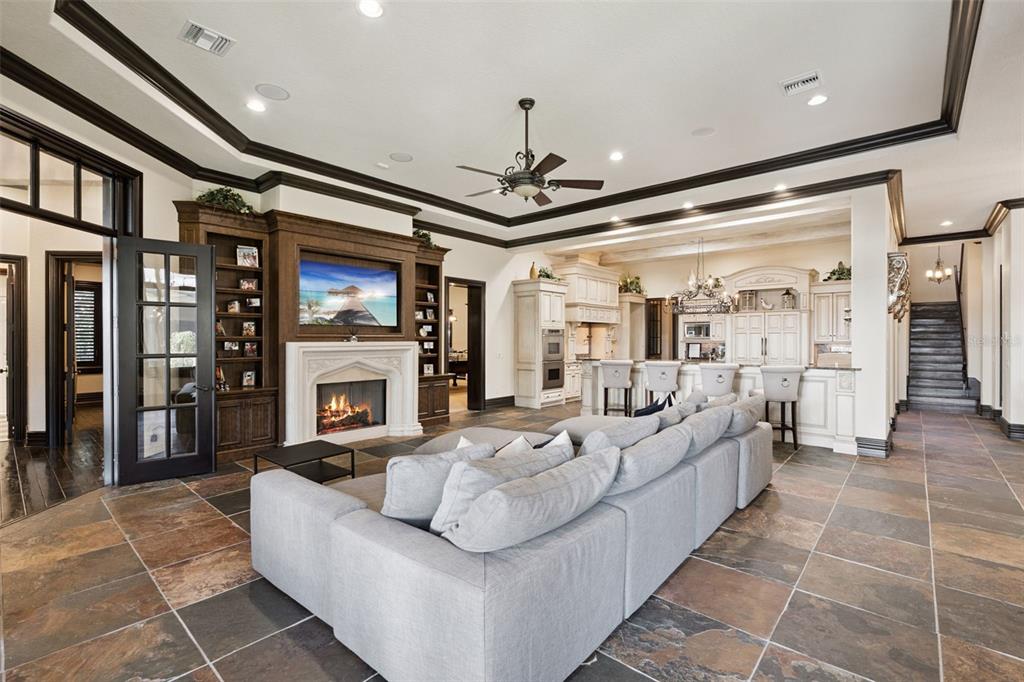 6507 Rosella Court Windermere, FL 34786 - Photo 11 of 92 a living room with furniture a fireplace and a chandelier