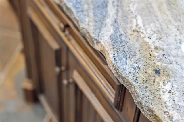 a kitchen with stainless steel appliances granite countertop a refrigerator a stove and a sink