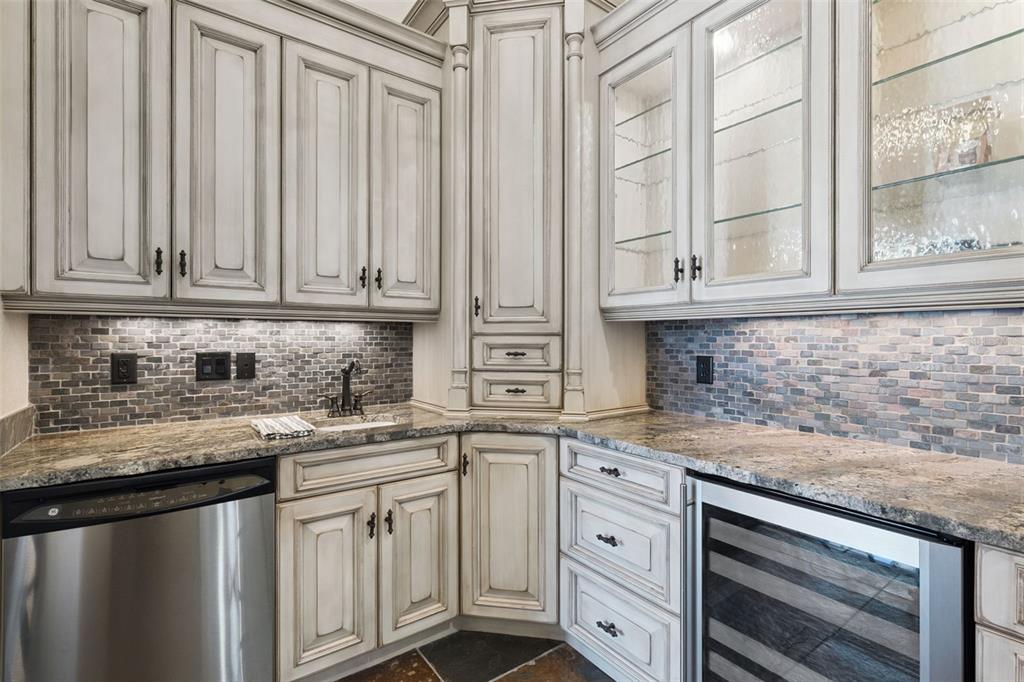 6507 Rosella Court Windermere, FL 34786 - Photo 26 of 92 a kitchen with stainless steel appliances granite countertop a sink and dishwasher with white cabinets