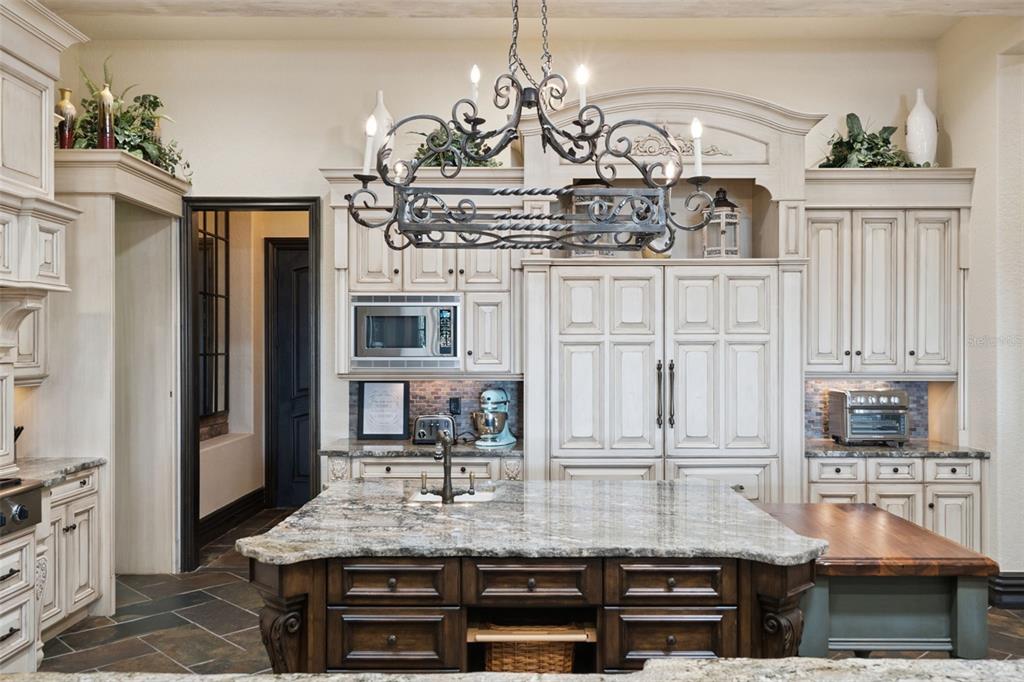 6507 Rosella Court Windermere, FL 34786 - Photo 27 of 92 a kitchen with stainless steel appliances granite countertop a stove and cabinets