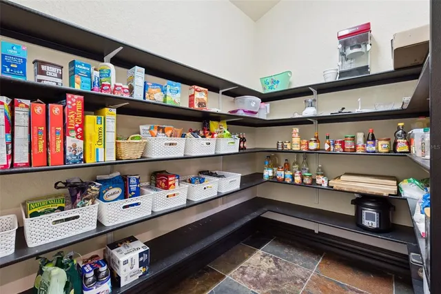 a living room with furniture a table and potted plants