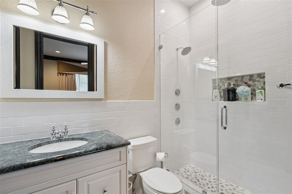 6507 Rosella Court Windermere, FL 34786 - Photo 54 of 92 a bathroom with a granite countertop sink toilet and shower