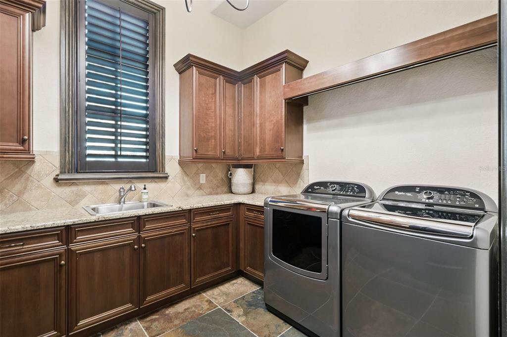 6507 Rosella Court Windermere, FL 34786 - Photo 58 of 92 a kitchen with stainless steel appliances granite countertop a sink and a stove