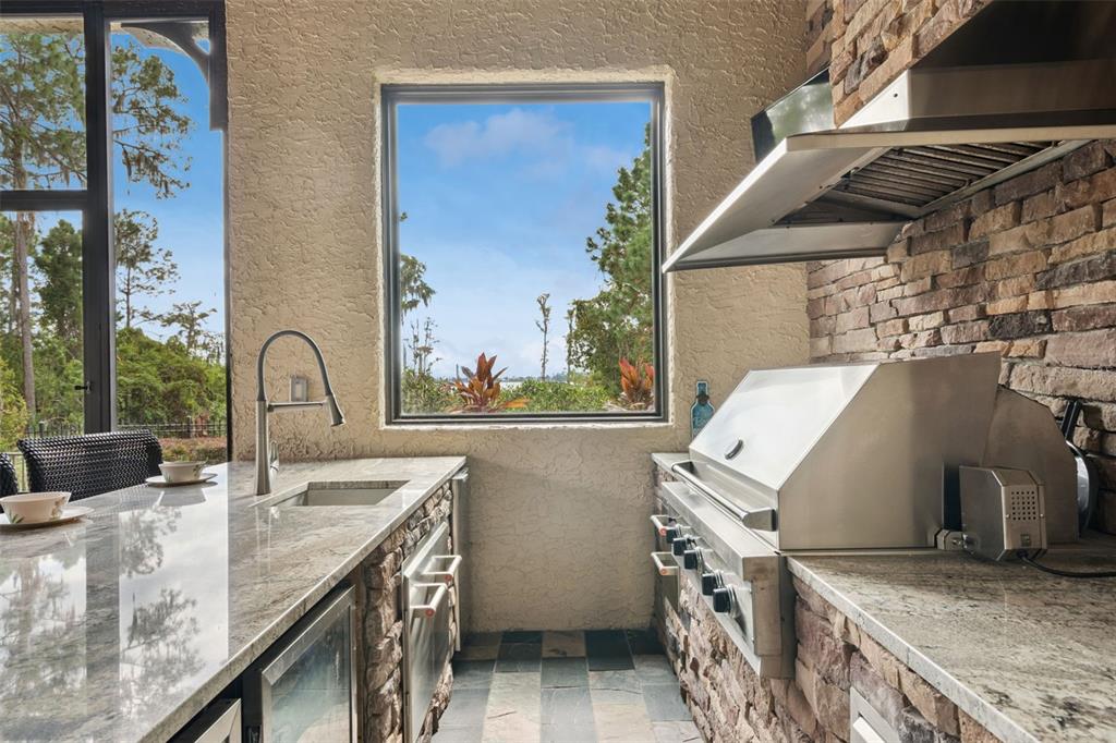 6507 Rosella Court Windermere, FL 34786 - Photo 66 of 92 a bathroom with a granite countertop sink and a washing machine