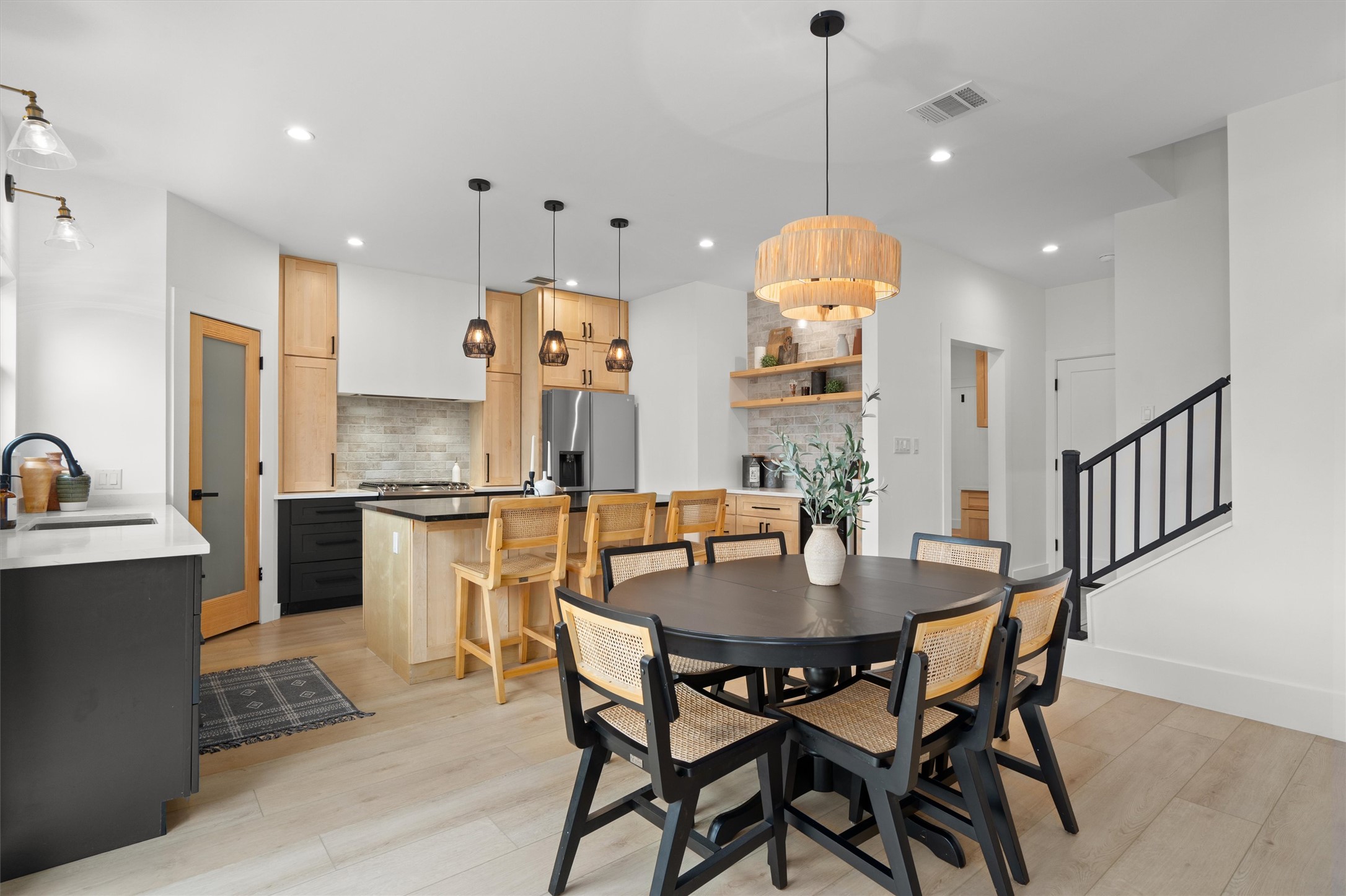 1108 Dunman Drive Georgetown, TX 78628 - Photo 13 of 40 a kitchen with stainless steel appliances kitchen island granite countertop a table chairs and a refrigerator