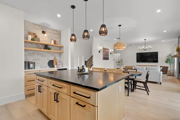 a kitchen with a table chairs and a refrigerator