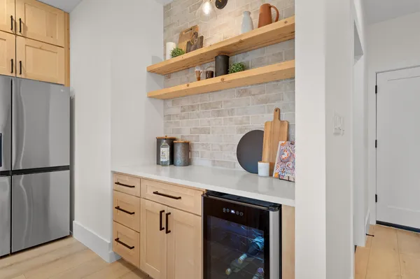 a kitchen with stainless steel appliances a refrigerator and cabinets