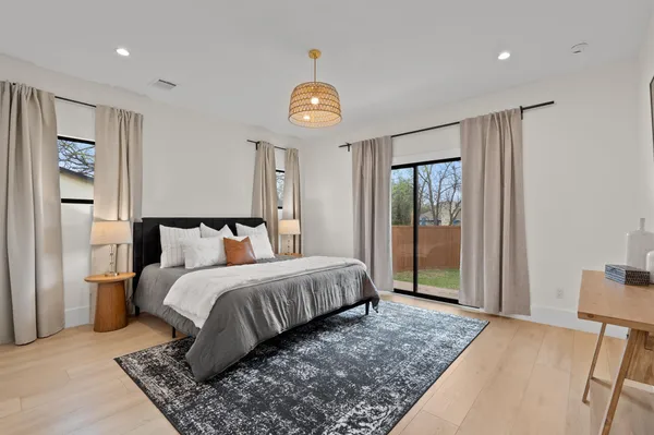 a bedroom with a bed and a lamp on table