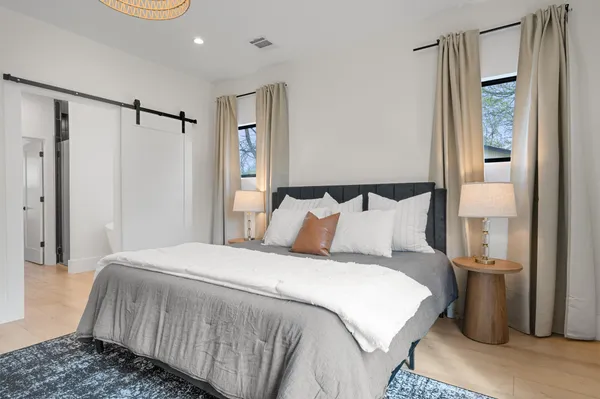 a bedroom with a bed and a mirror