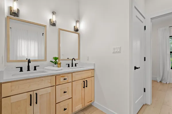 a bathroom with a double vanity sink and mirror