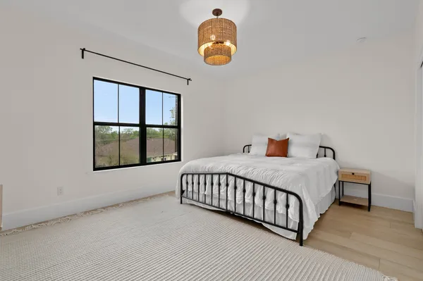 a bedroom with a bed and window