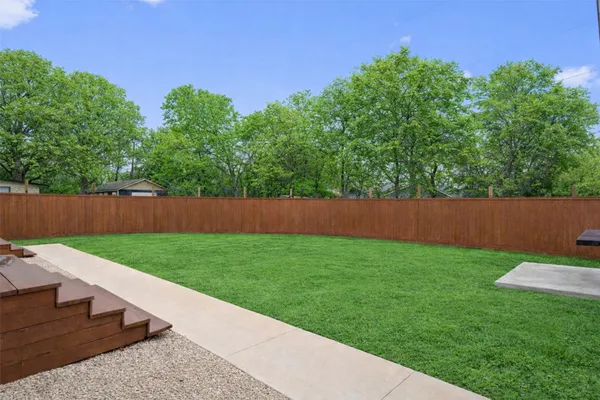 a view of a house with yard and a patio
