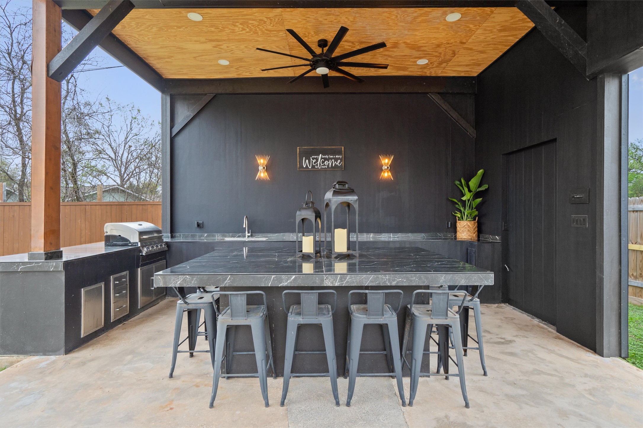 1108 Dunman Drive Georgetown, TX 78628 - Photo 38 of 40 a kitchen with stainless steel appliances kitchen island granite countertop a table chairs in it and wooden floor