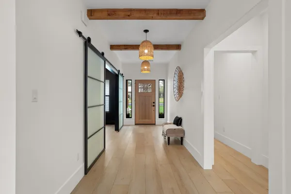 a view of a hallway with wooden floor and workspace