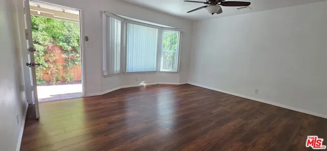 a view of wooden floor and windows in a room