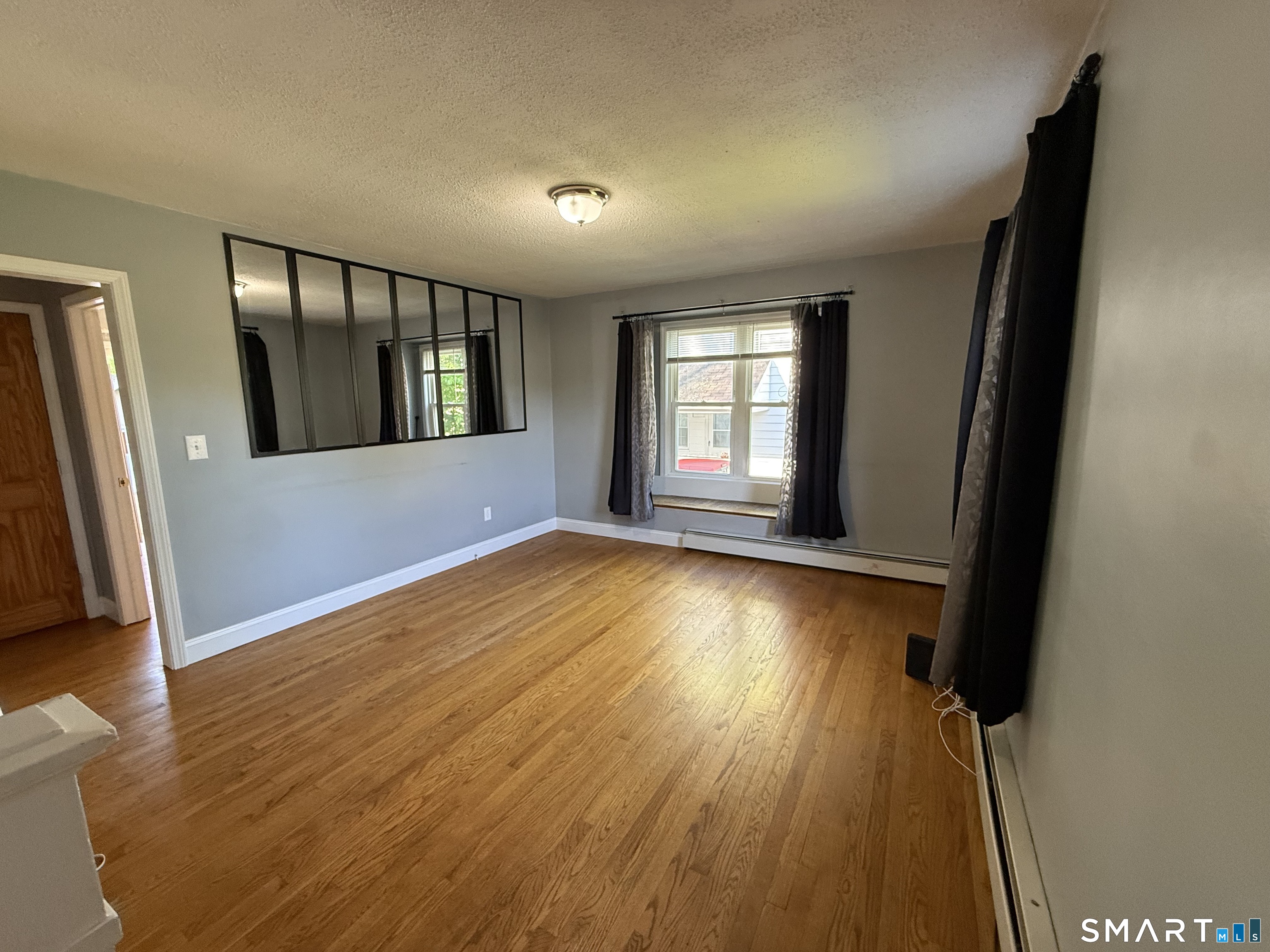 808 East Main Street Torrington, CT 06790 - Photo 23 of 40 wooden floor in an empty room with a window