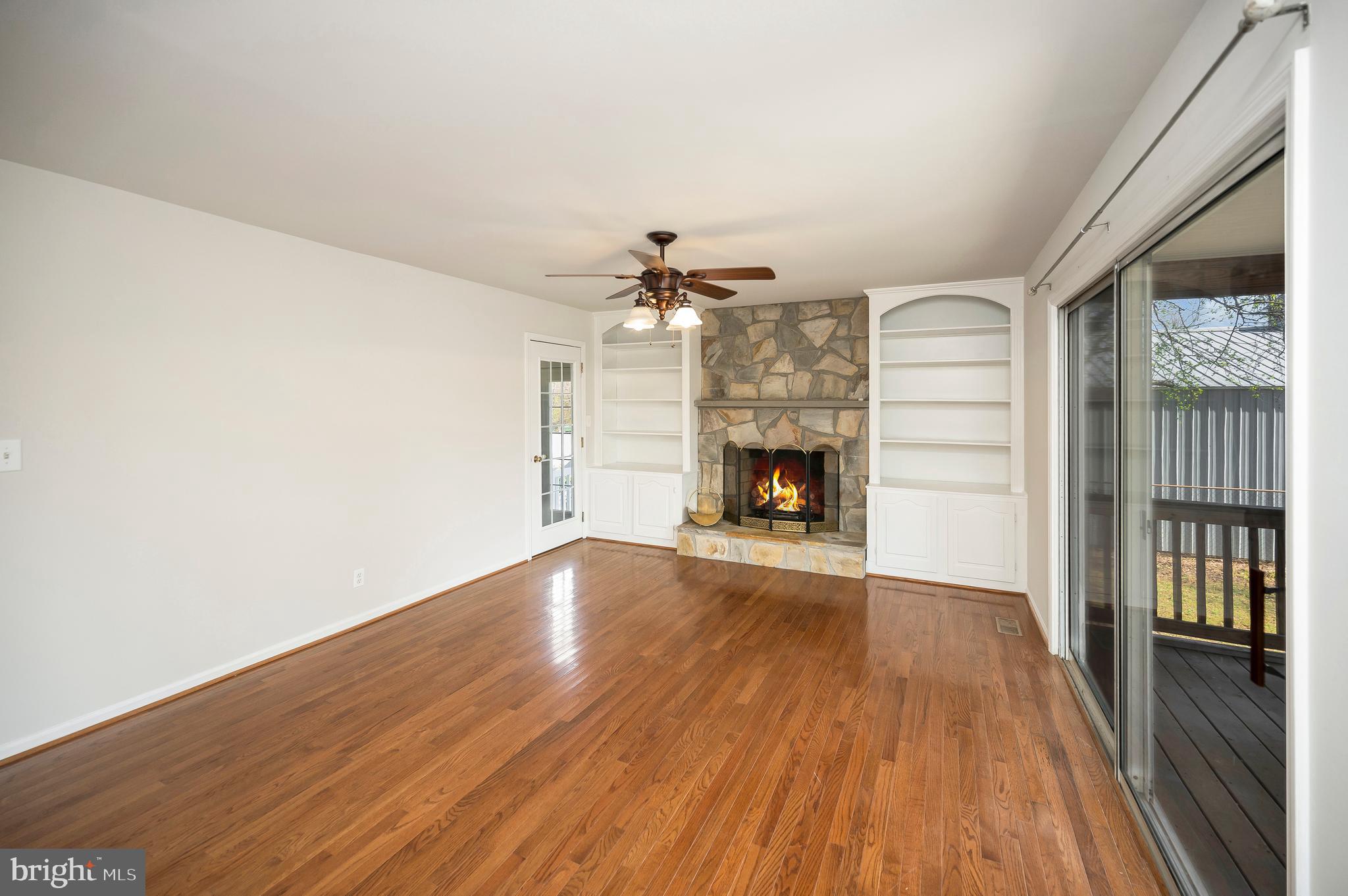 48 Belle Plains Road Fredericksburg, VA 22405 - Photo 23 of 51 an empty room with wooden floor a fireplace and entryway