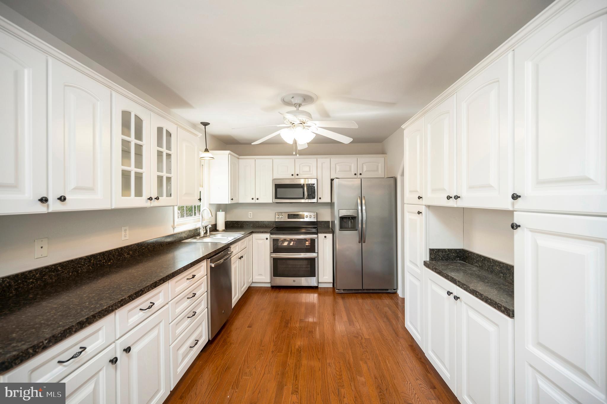 48 Belle Plains Road Fredericksburg, VA 22405 - Photo 27 of 51 a large kitchen with cabinets wooden floor and stainless steel appliances