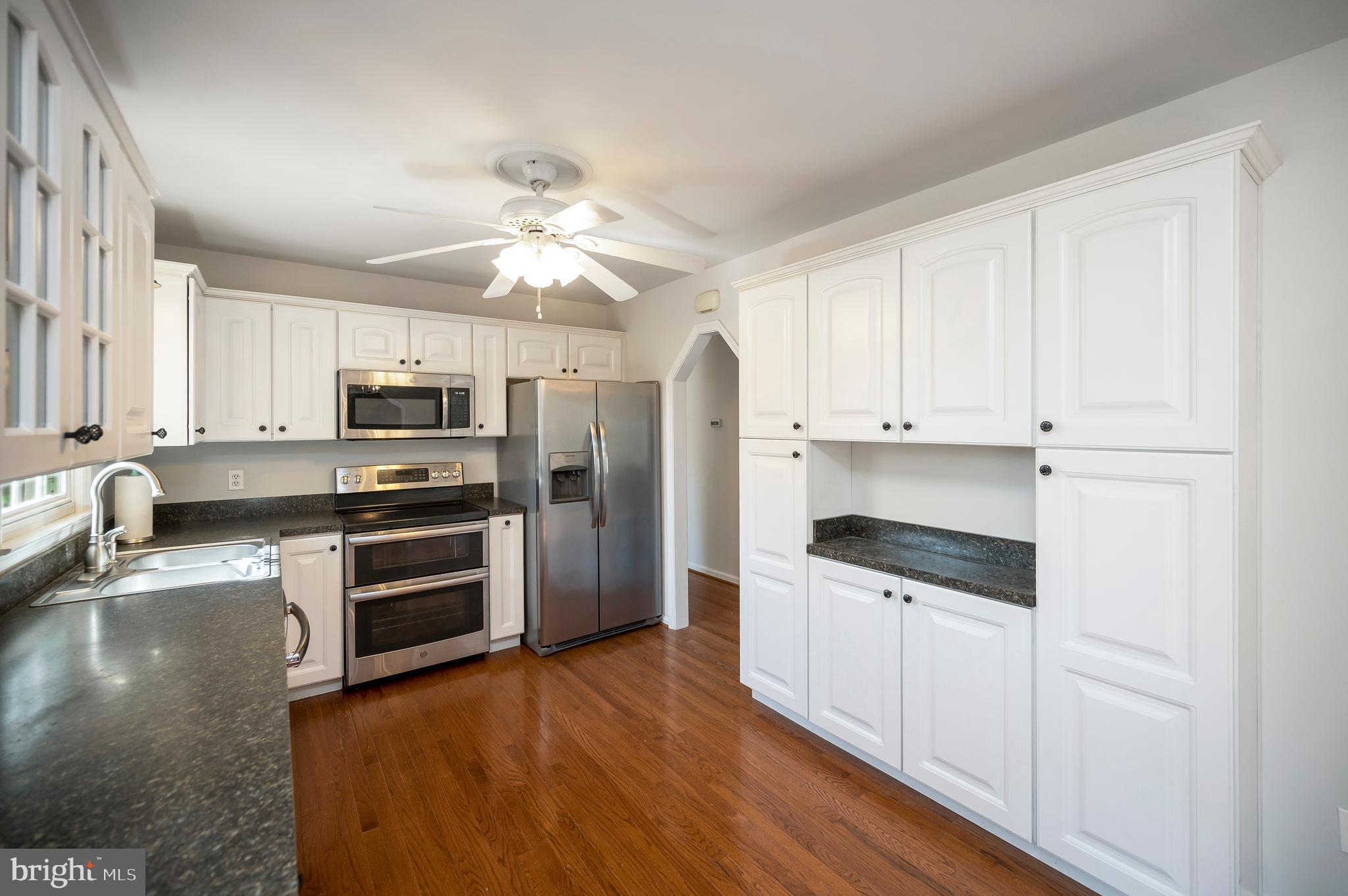 48 Belle Plains Road Fredericksburg, VA 22405 - Photo 29 of 51 a kitchen with stainless steel appliances a stove a refrigerator and white cabinets