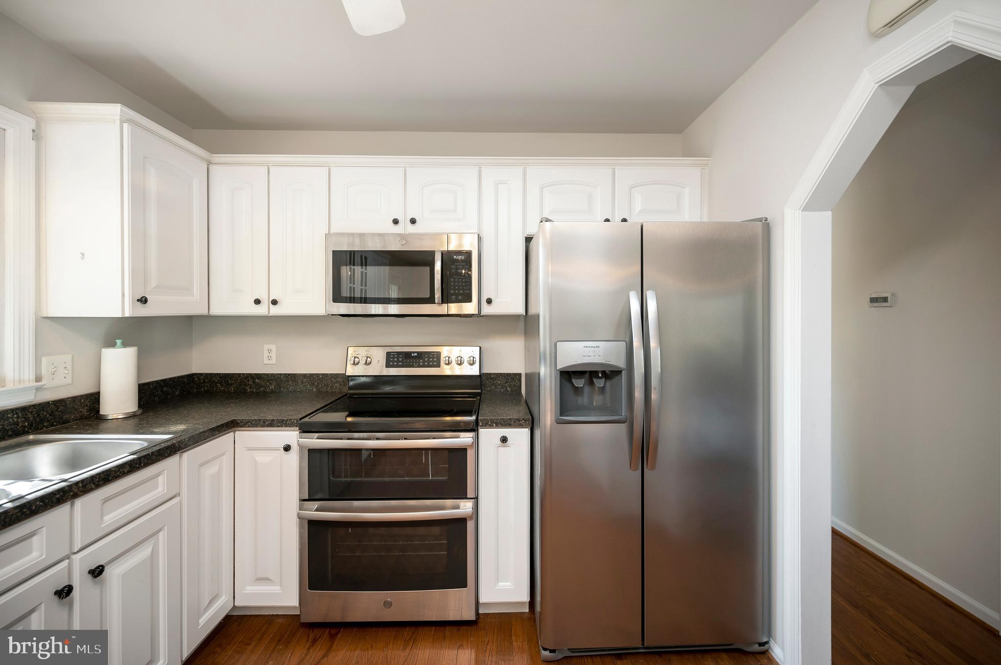 48 Belle Plains Road Fredericksburg, VA 22405 - Photo 30 of 51 a kitchen with cabinets stainless steel appliances and wooden floor