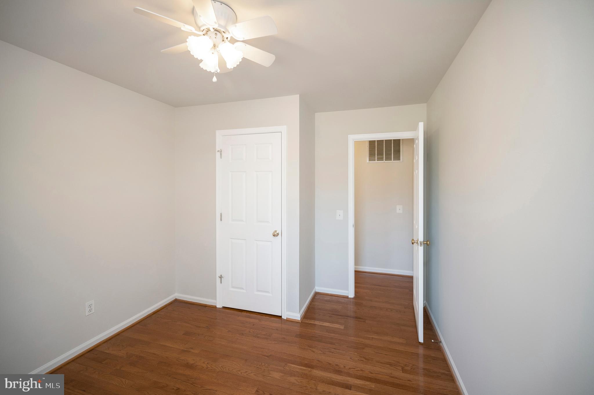 48 Belle Plains Road Fredericksburg, VA 22405 - Photo 40 of 51 a view of an empty room with wooden floor and a ceiling fan