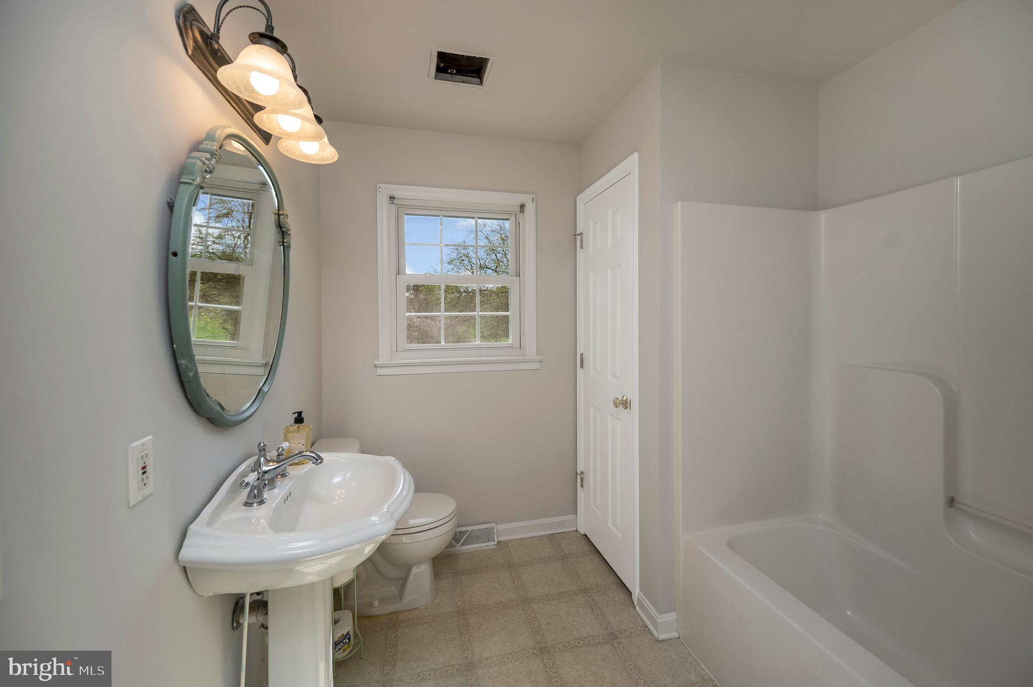 48 Belle Plains Road Fredericksburg, VA 22405 - Photo 41 of 51 a bathroom with a sink mirror and a bathtub