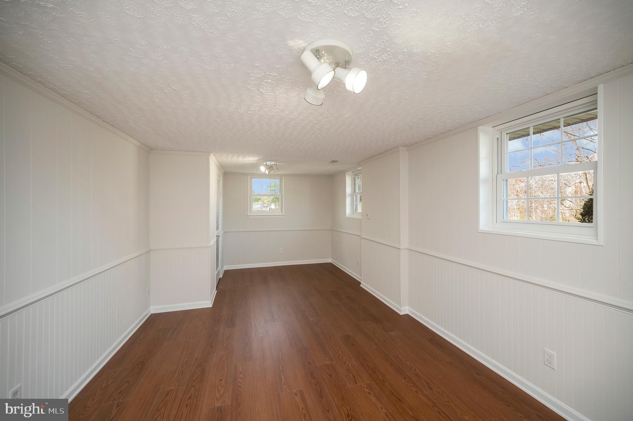 48 Belle Plains Road Fredericksburg, VA 22405 - Photo 48 of 51 an empty room with wooden floor and windows