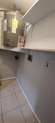 a view of a kitchen with a refrigerator a stove top oven and cabinets
