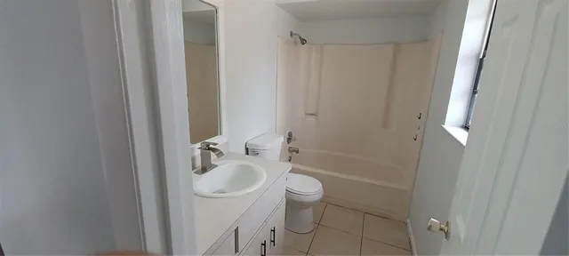 a view of a room with wooden floor and window