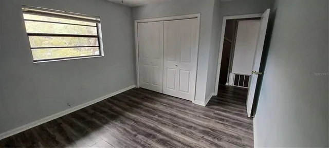 a view of a room with wooden floor