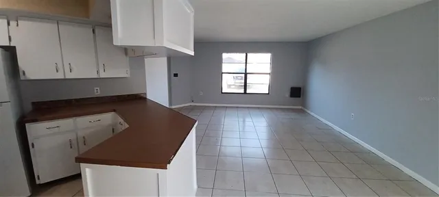 a kitchen with white cabinets and a stove