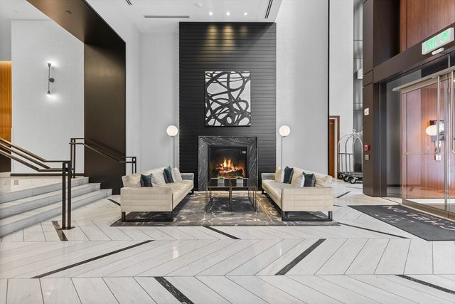 a living room with fireplace furniture and a fireplace