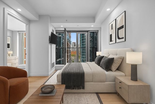 a bedroom with a bed and a couch