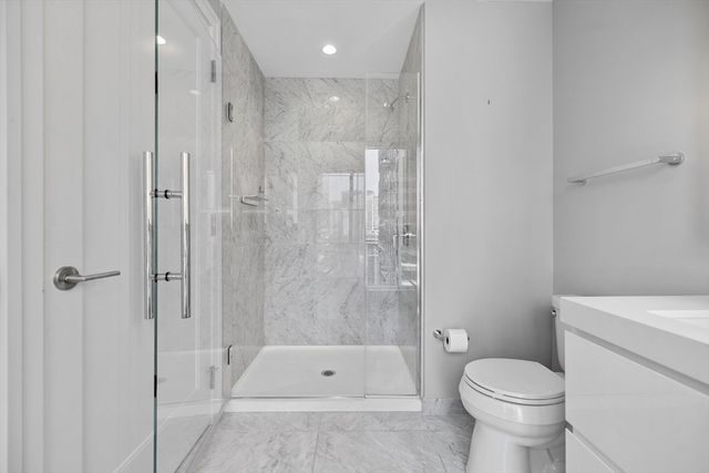 a bathroom with a toilet and a shower