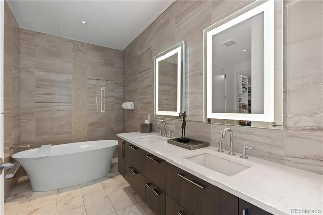 a bathroom with a large tub sink and mirror