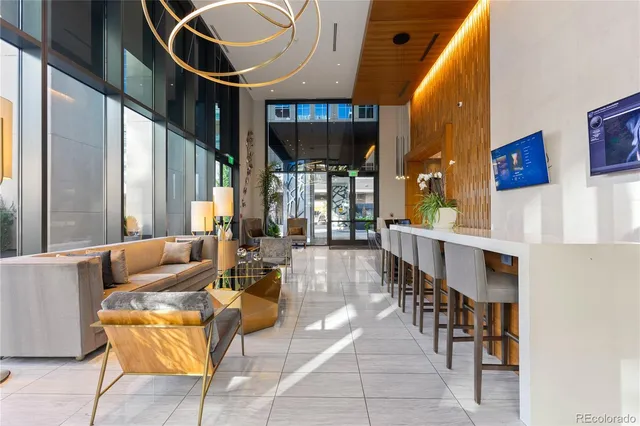 a living room with couches a dining table and chairs with wooden floor