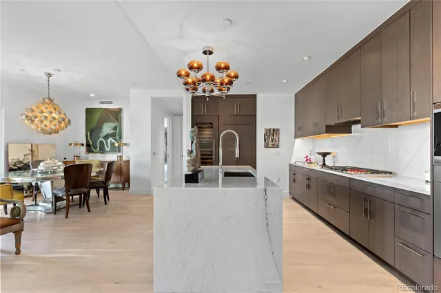 a view of a kitchen with dining area a sink and dishwasher